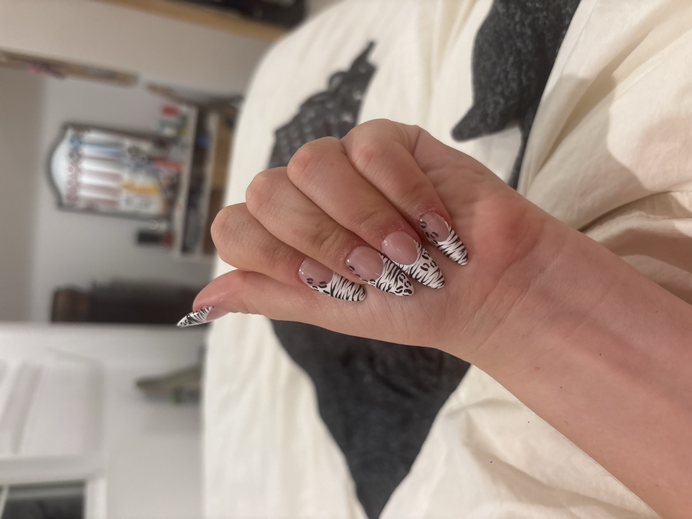 Almond press-on nails with black-and-white zebra and leopard print french tips